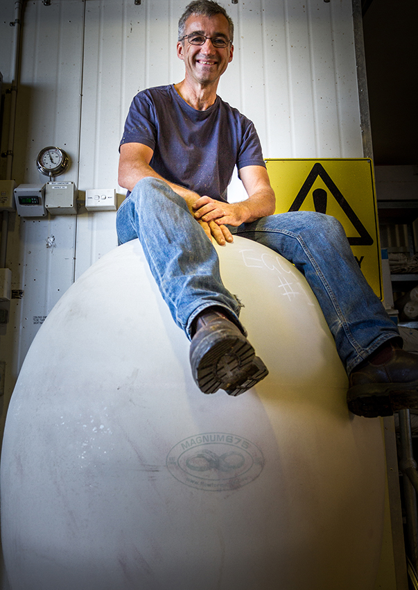 Bryan Martin sitting on a ceramic egg